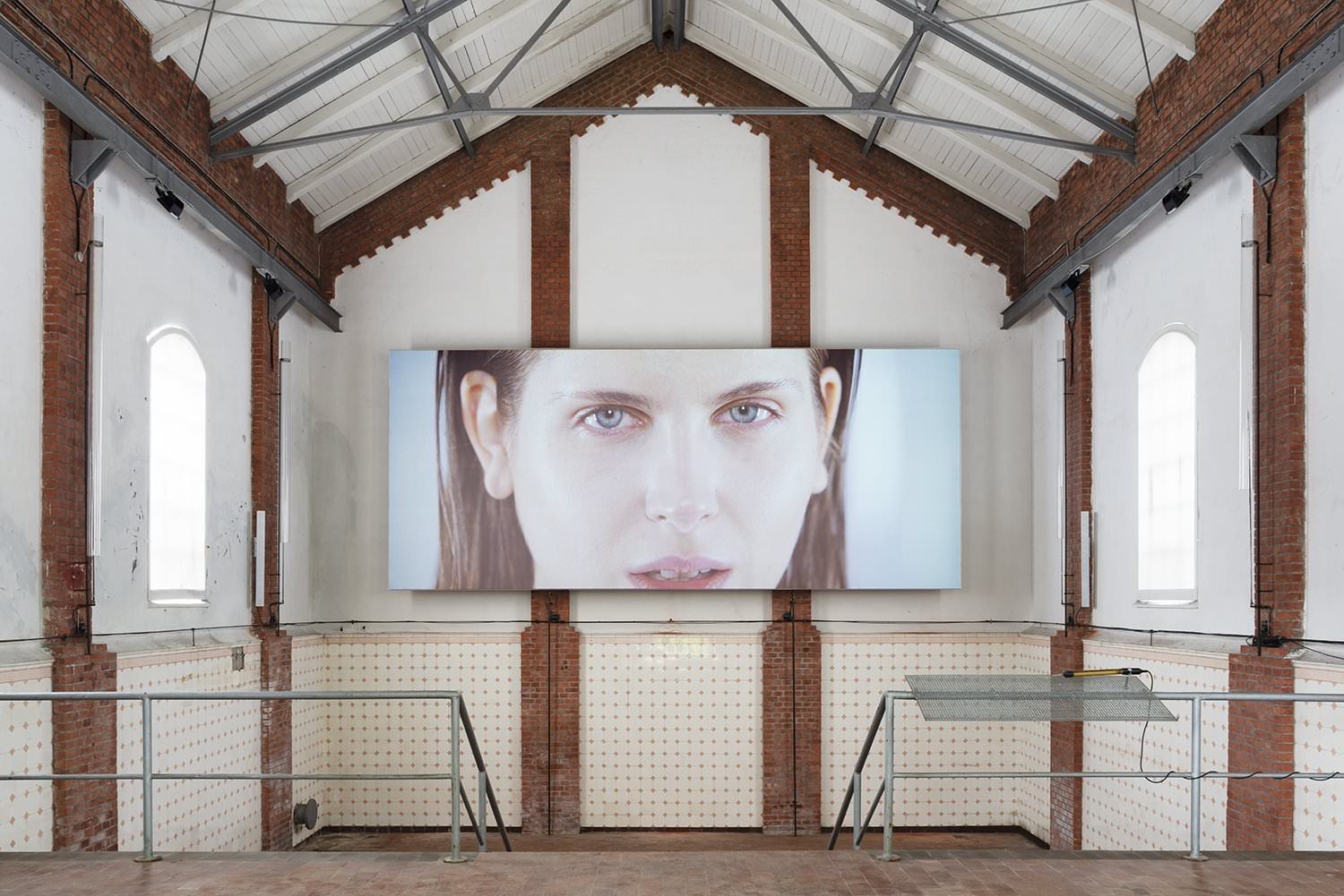 Xavier Cha, abduct, the wide screen with a face in the brick hall