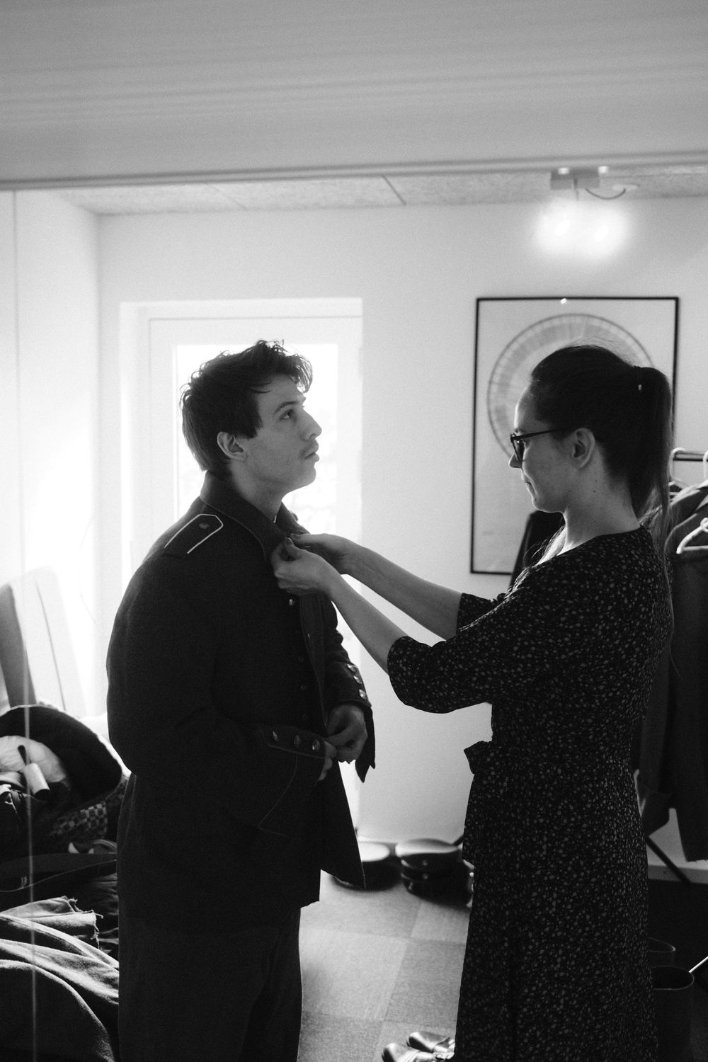 Behind the scenes, costume fitting by the window