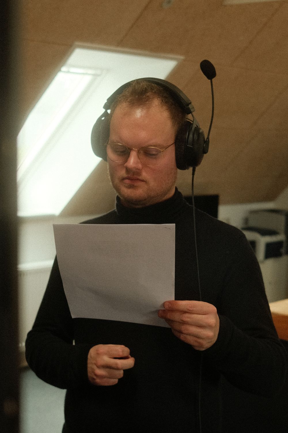 Behind the scenes, director with headphones reading the script