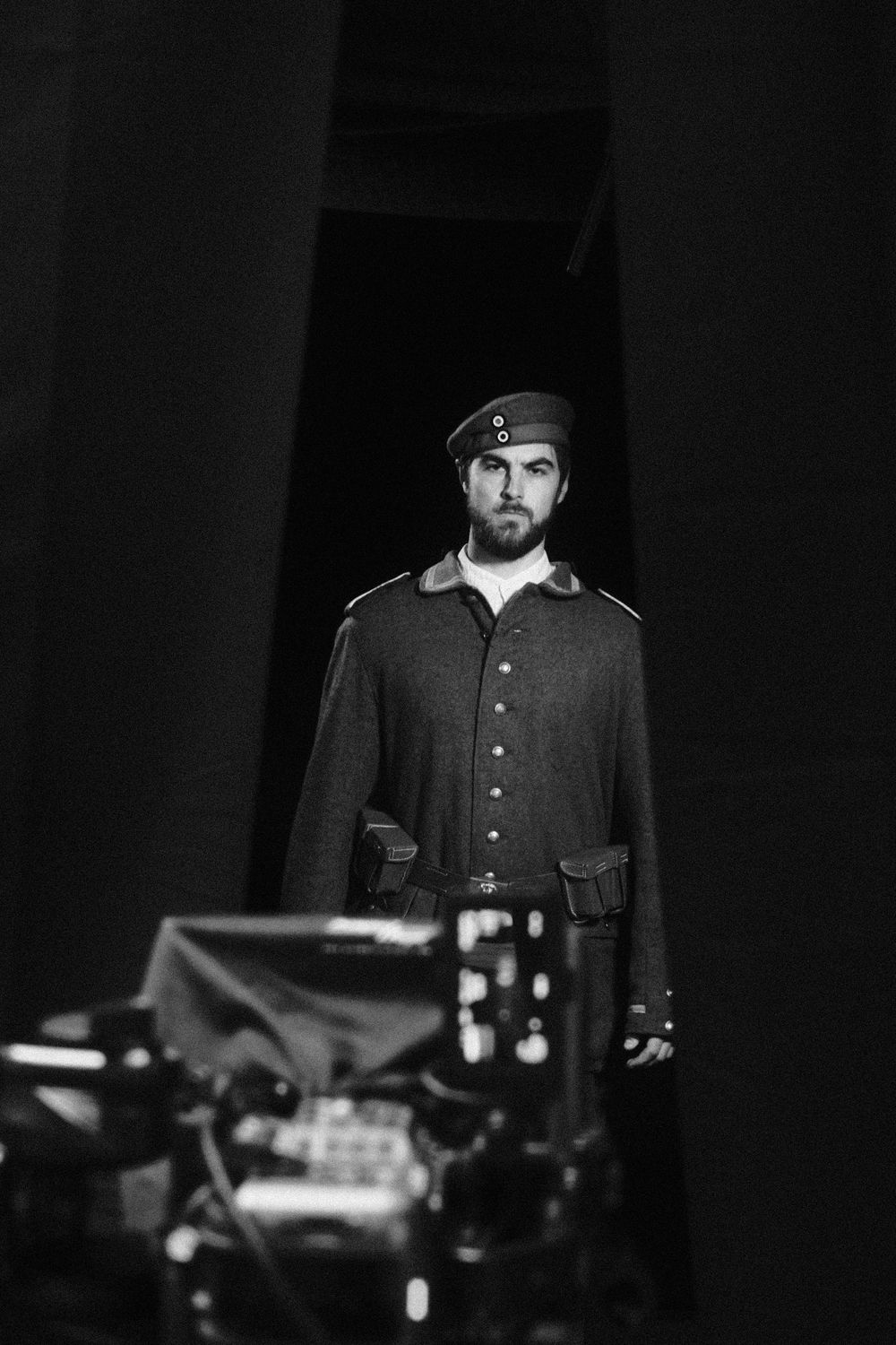 Behind the scenes, actor in soldier's uniform behind the camera