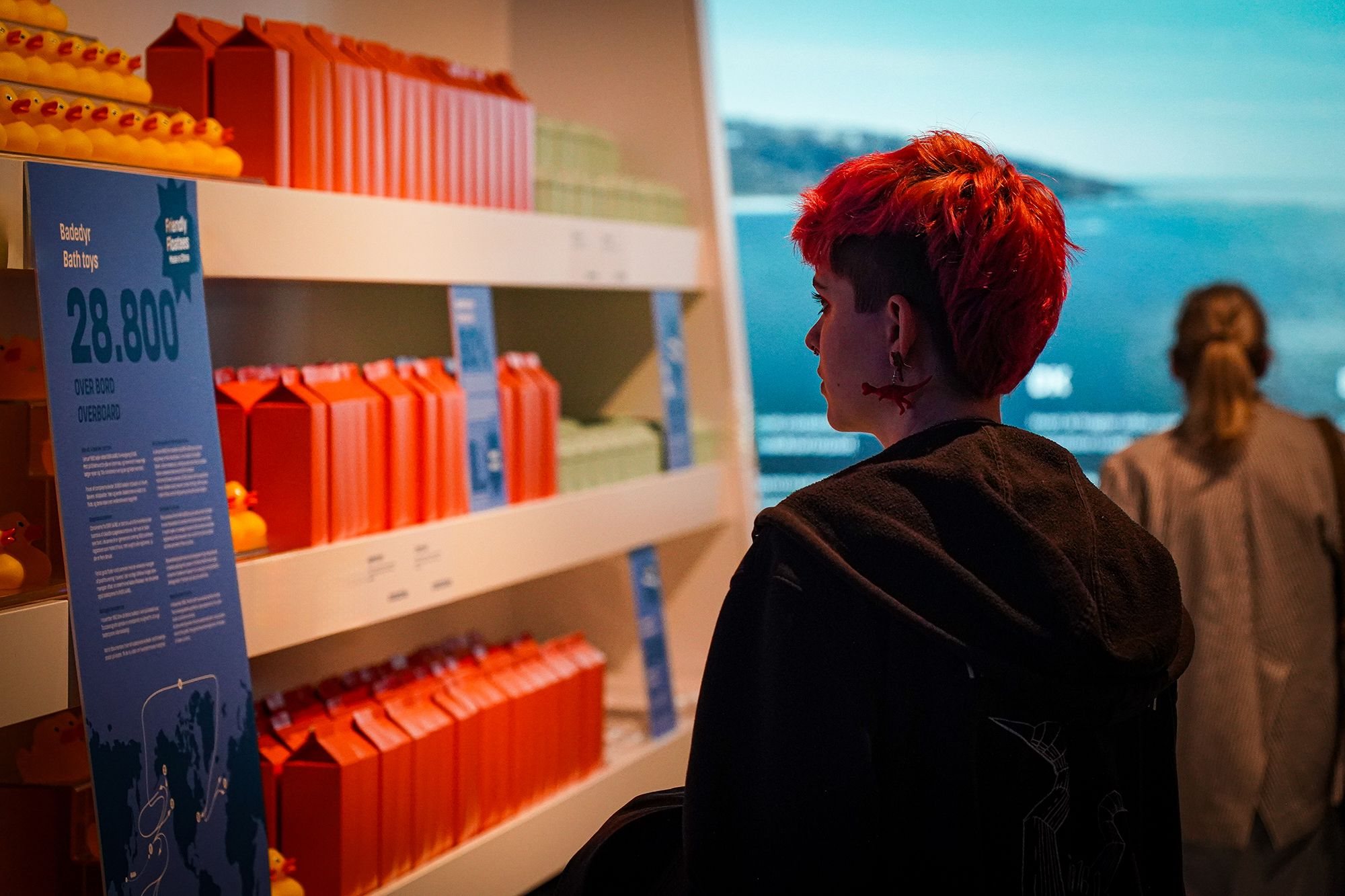 Søfarer, the Greenlandic shop shelves with a visitor looking out at the projected sea